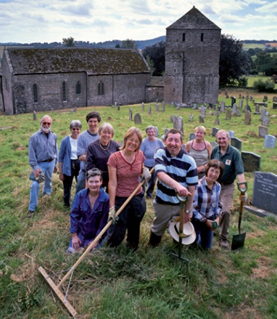 Volunteers working in the graveyard of St Mary Magdalene, Leintwardine, Herefordshire