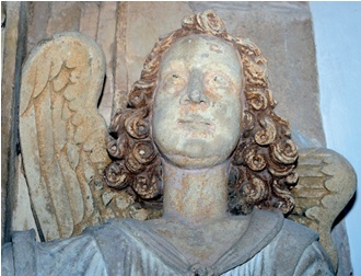 Residues of historic pigment visible on the head and hair of a stone angel