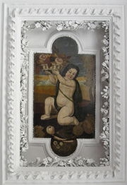 Polychrome painted cherub framed by elaborately patterned plasterwork
