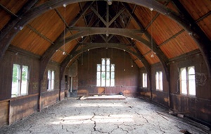 Interior of CI church roof with arch-braced timber roof trusses
