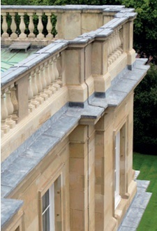 Neatly detailed leadwork capping rooftop balustrade and projecting cornices on a historic facade
