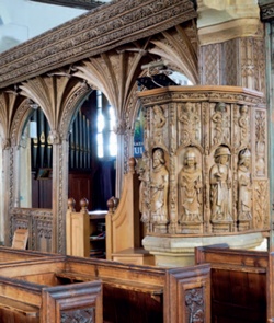 Richly carved timber pulpit and rood screen