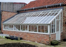 Lean-to conservatory abutting brick building with pantile roof