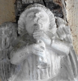 Stone angel with woodwind instrument
