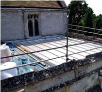 New stainless steel roof being laid behind stone parapet