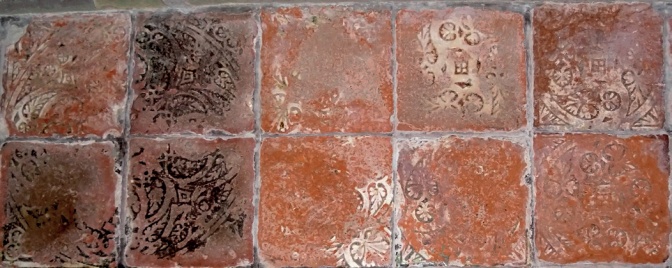 Encaustic floor tiles with most of the pattern worn away
