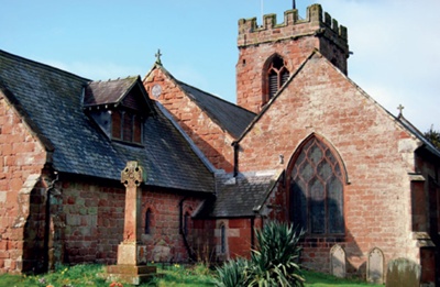 St John the Baptist with filled in archway visible in exterior masonry wall