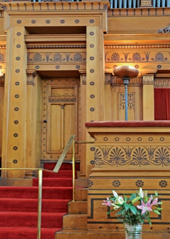 Pulpit platform, doorway and section of wall decorated with elaborate patterned borders referencing classical forms