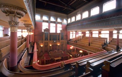 Wide-angle view from gallery with sun streaming in through windows