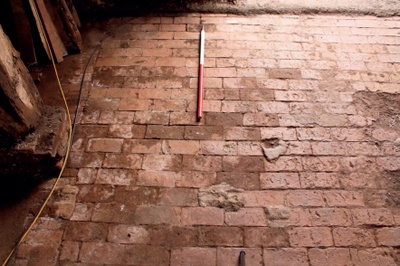 Original brick threshing floor in a historic barn
