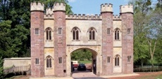 Ashlar lodge with polygonal turrets and embattled parapet (c1840)