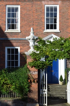 Historic brick gate pier with Georgian town-house facade behind