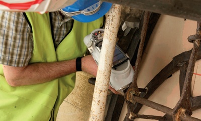 A conservator uses a X-ray fluorescence reader to analyse 