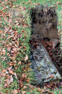 Chest tomb which has fallen into void beneath which appears to be at least 3 feet deep