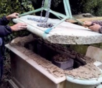 The lid is winched back into place; a block core can be seen inside the chest tomb and all upper faces that will bear the lid's weight have had lime mortar applied