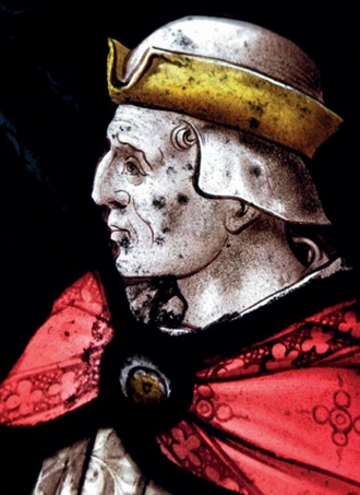 Small dark spots of mould growth on a stained glass window 