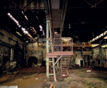 Iron works interior with parallel lines of holes in CI roof caused by corrosion