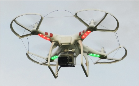 Hovering drone photographed from below