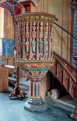 Brightly coloured and richly carved pulpit with ploygonal timber shaft and stone base at Long Sutton, Somerset