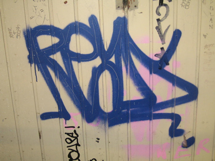 Graffiti on painted timber panelling