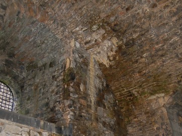 Darker areas of staining to a vaulted masonry ceiling