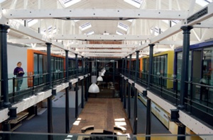 Interior of a converted industrial building with painted cast iron columns and beams