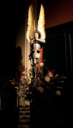 Polychrome statue of winged St Michael holding sword and scales