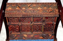 Colour photo of tracery heads and soffit panels at Newtown with rich red and gold colour scheme