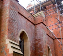 Church brickwork marked by white bloom