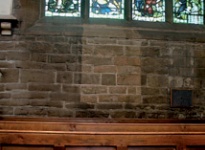 Panel of clean brickwork below stained glass window