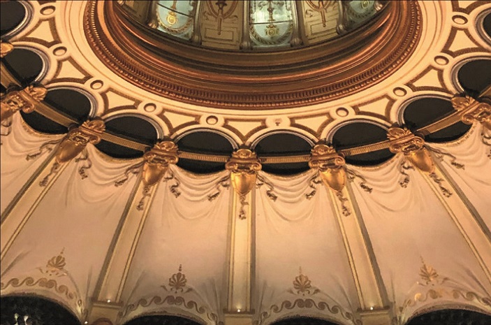 Detailed close-up of the London Coliseum's ceiling interior