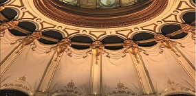 Detailed close-up of the London Coliseum's ceiling interior