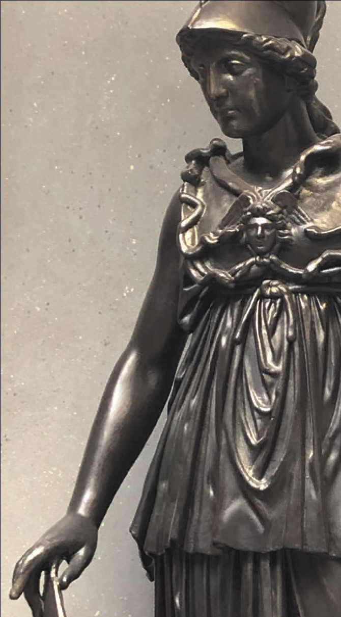 A close-up photo showing the bronze finish on the statue front