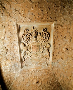 The King's Room ceiling with complex strapwork surrounding heraldic panel