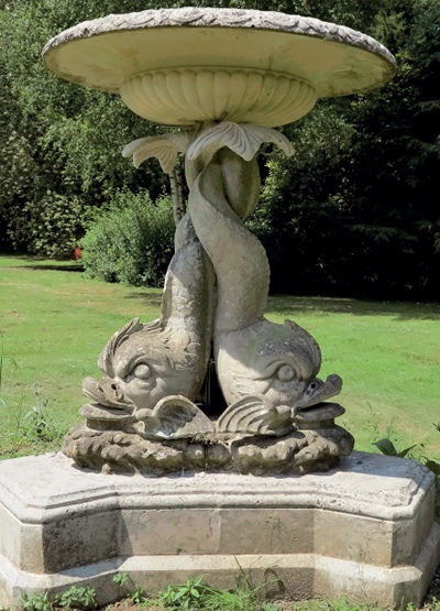 Artificial stone garden ornament with bowl supported on two entwined dolphins' tails