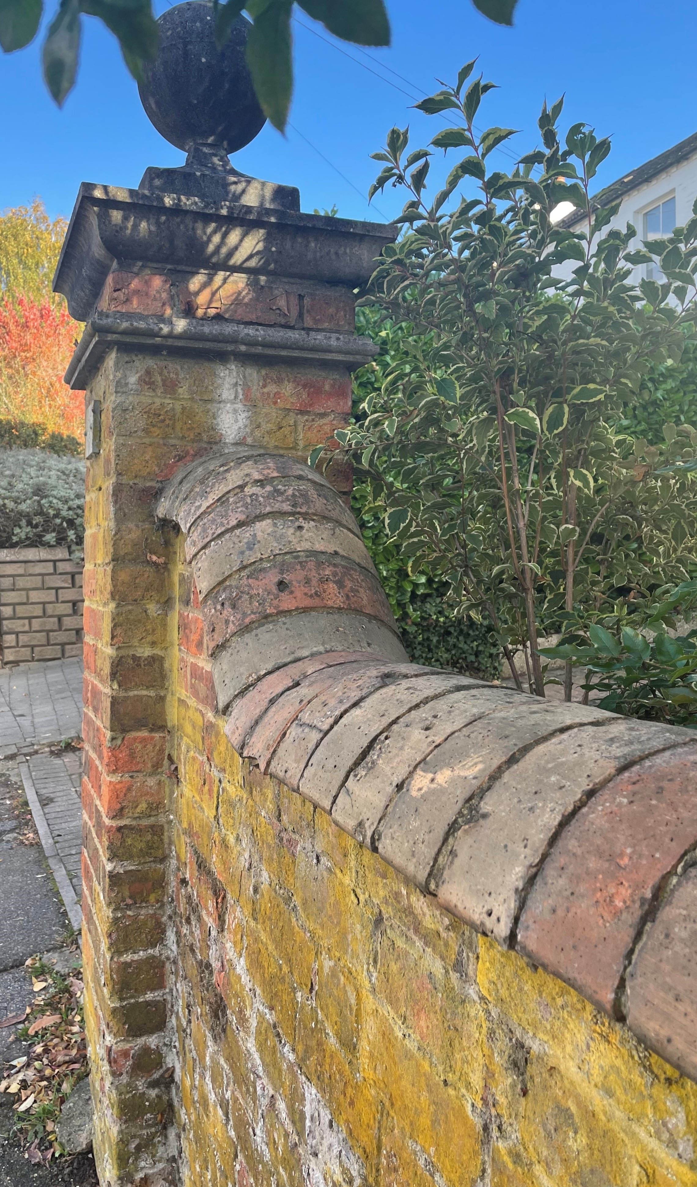 A magnificent garden wall capped with rounded brick copings