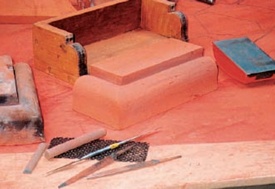 Modern replacement brick made using traditional methods shown beside the box and block used to make it and a selection of metal files
