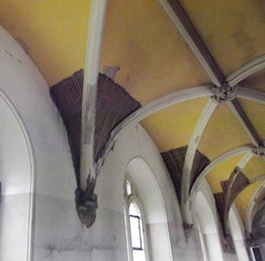 Water damage to plasterwork of vaulted church ceiling