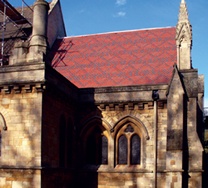 Church roof with banding and diamond-shaped patterning formed using colour variation in polychromatic clay tiles