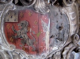Marble cartouche with heraldic design before and after cleaning