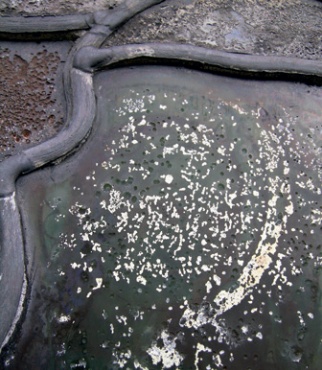 Pitting of glass surface caused by corrosion