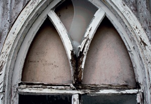 Decay to poorly maintained timber window frame in a CI-clad chapel