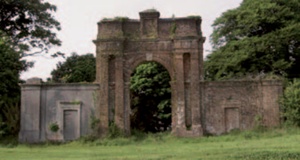 Boringdon Arch: A late 18th century triumphal arch and flanking buildings in red brick and stucco
