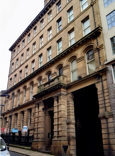 Imposing stone facade and portico of a Victorian office building in the Little Germany merchant quarter, Bradford