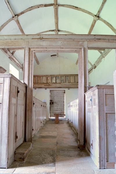 Low angle photo of the church interior showing box pews, gallery and barrel-vaulted ceiling
