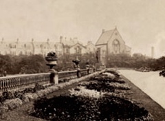 Black and white photograph of the hall in the distance and its original setting