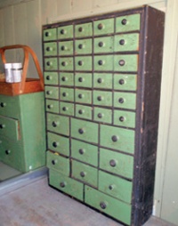 Timber seed safe with rows of small drawers