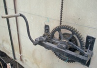 Ventilator operating gear including crank handle, cogs, chain reel and ratchet