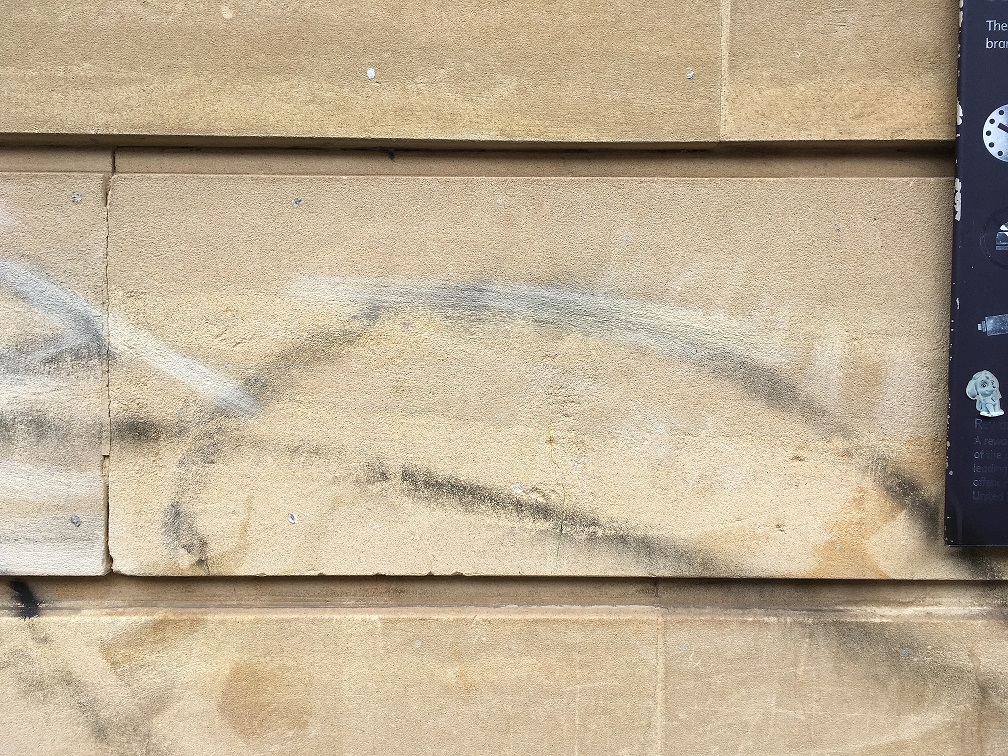 marks left by graffiti removal attempt