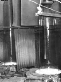 b/w photo showing cylinder glass being 'drawn'